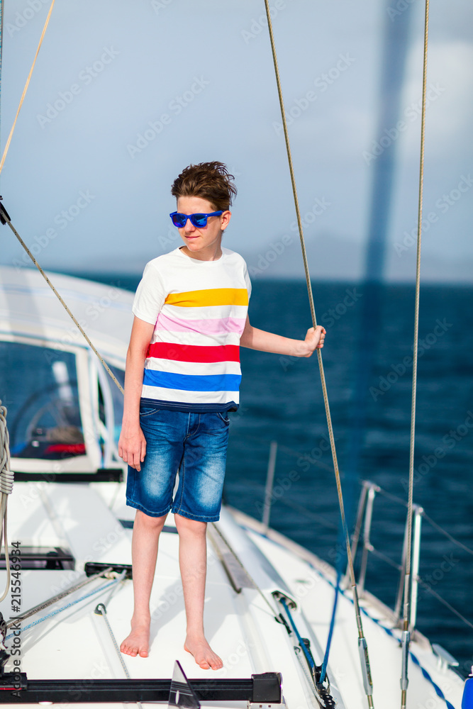 Teenage boy on board of sailing yacht Teenage boy on board of sailing yacht