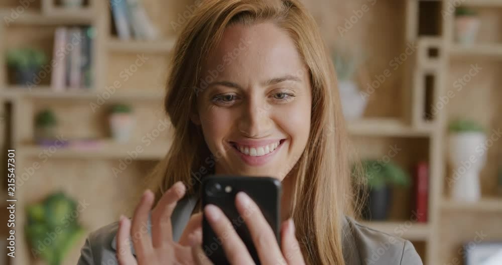 close up portrait of beautiful young woman using smartphone enjoying browsing online sending messaging smiling happy satisfaction