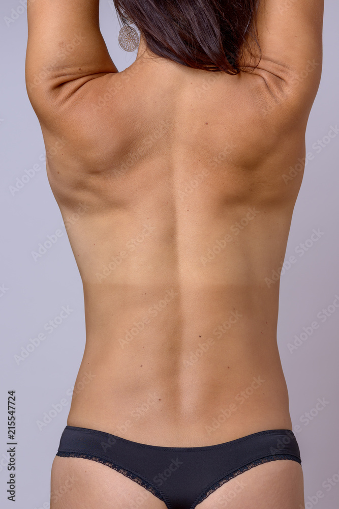 Bare back of a slender athletic toned woman Stock Photo