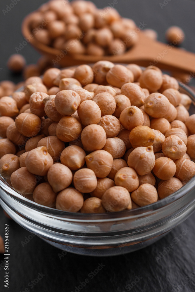 uncooked chickpeas on a dark stone background uncooked chickpeas on a dark stone background