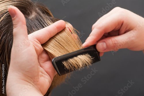 Combing blond hair with brush