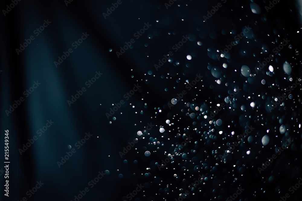 Bokeh of water fly and lights on black and blue background,abstract background all colors bokeh circles for background.