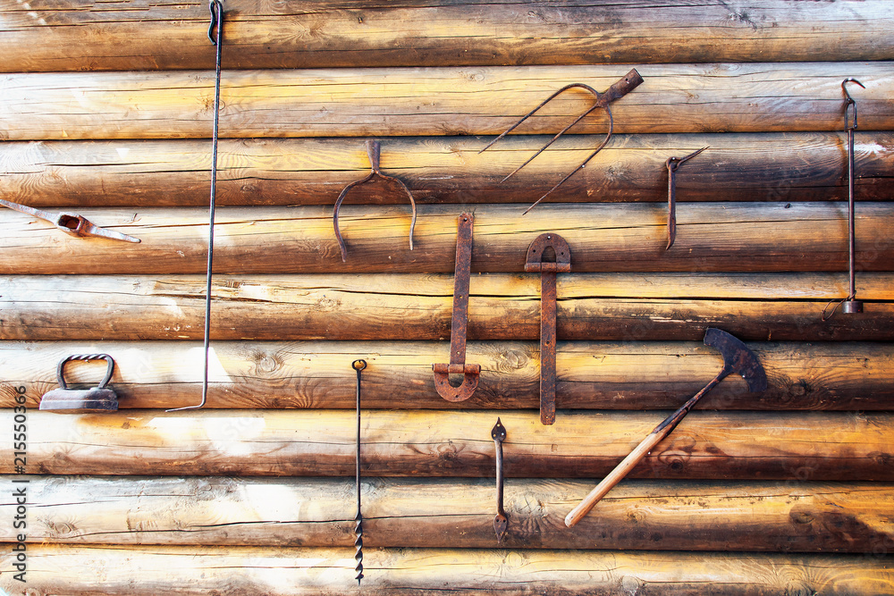 historical tools hanging on a wooden wall