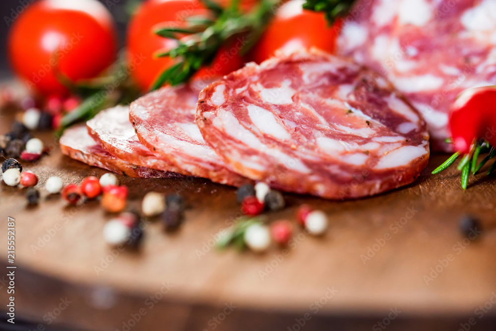 Tasty salami with tomatoes and peppercorn close
