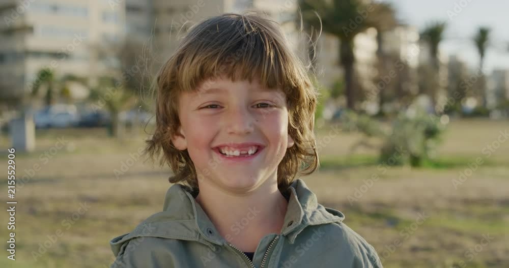 portrait of cute happy boy smiling cheerful at camera enjoying fun day on seaside park portrait of cute happy boy smiling cheerful at camera enjoying fun day on seaside park