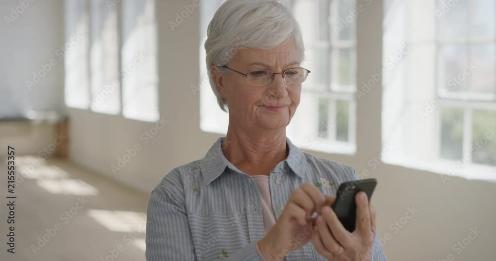 portrait of elderly woman using smartphone confused frustrated at broken mobile phone faulty electronic device