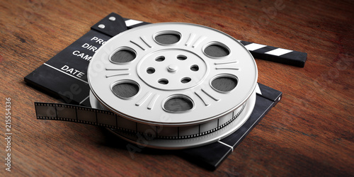 Film movie reel, on a movie clapper and a wooden background, 3d illustration.