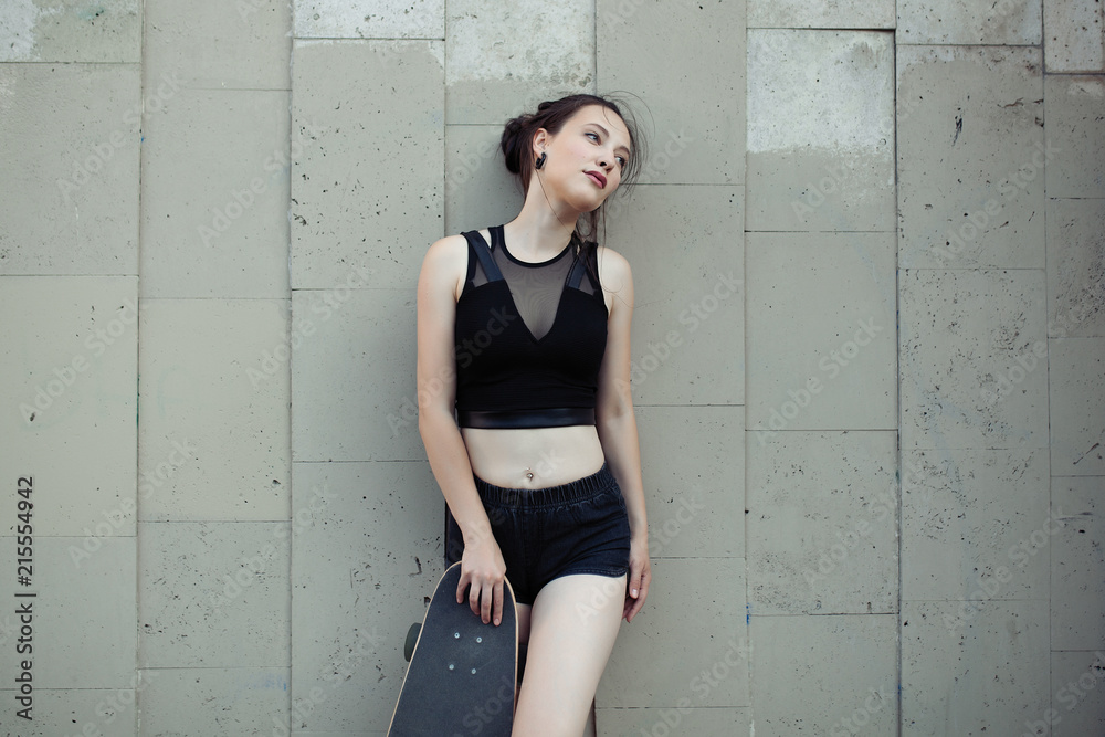 Beautiful young girl with a long board in the city. The concept of modern youth. Active fun holiday. Beautiful young girl with a long board in the city. The concept of modern youth. Active fun holiday.