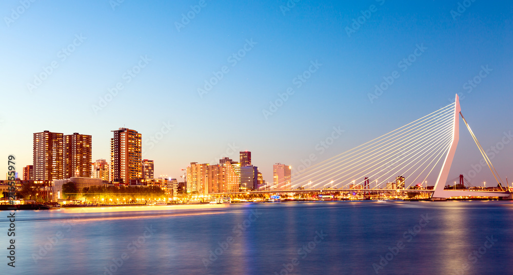 Rotterdam panorama. Erasmus bridge over the river Meuse with skyscrapers in Rotterdam, South Holland, Netherlands during twilight sunset.
