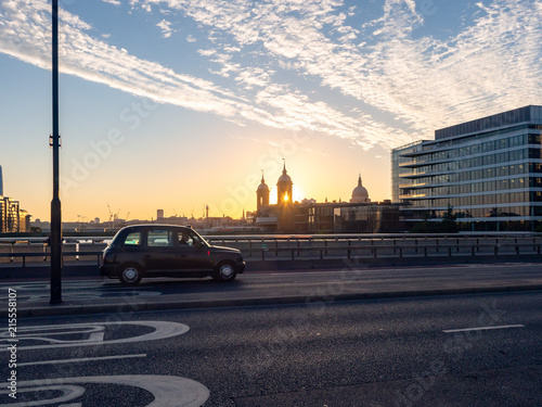 Obraz na plátně Taxi cab crossing London Bridge, UK