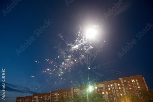 Fototapeta Naklejka Na Ścianę i Meble -  Festive fireworks over the apartment house at night.