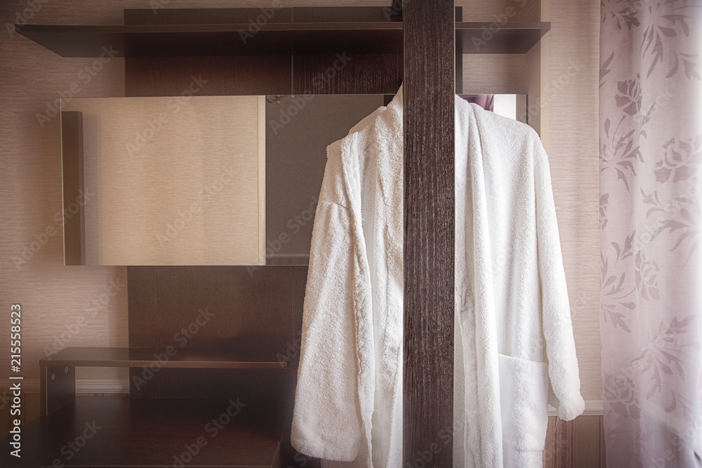 White terry robe in the hotel room's wardrobe.