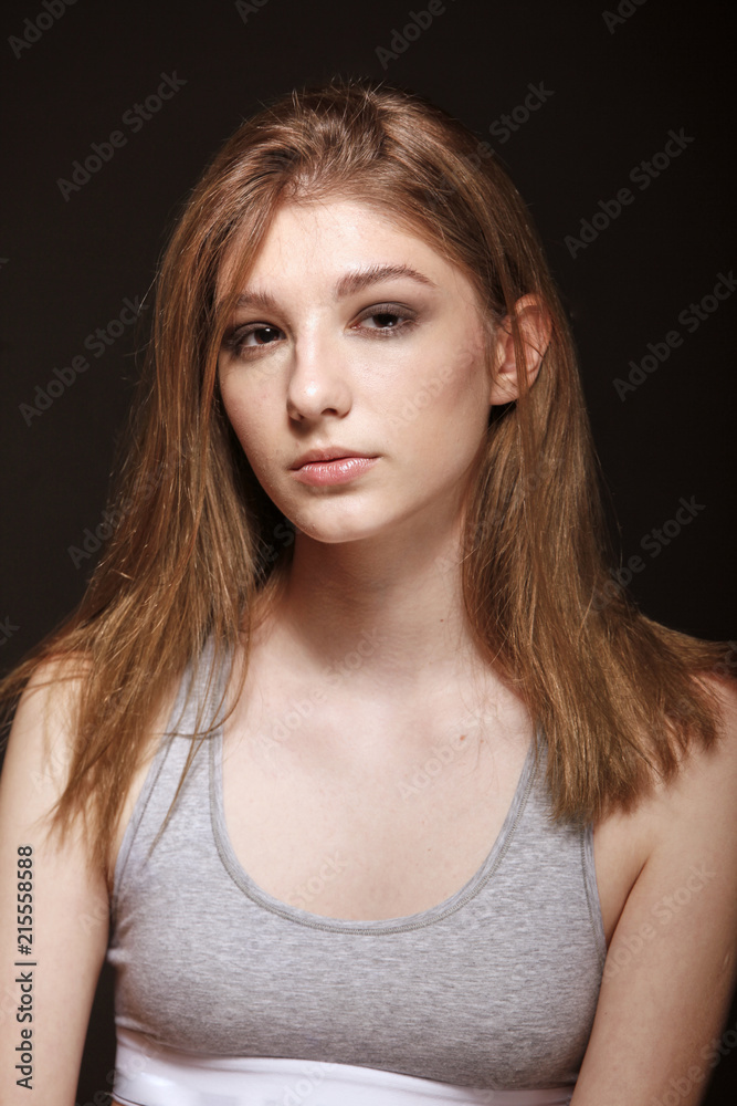 upper body, one young teenage girl, wearing top. fashion model, black background. upper body, one young teenage girl, wearing top. fashion model, black background.