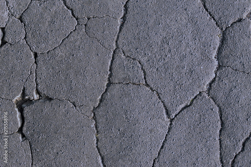 Fotografie cracks on the asphalt, road destruction, beautiful abstract background of cracks