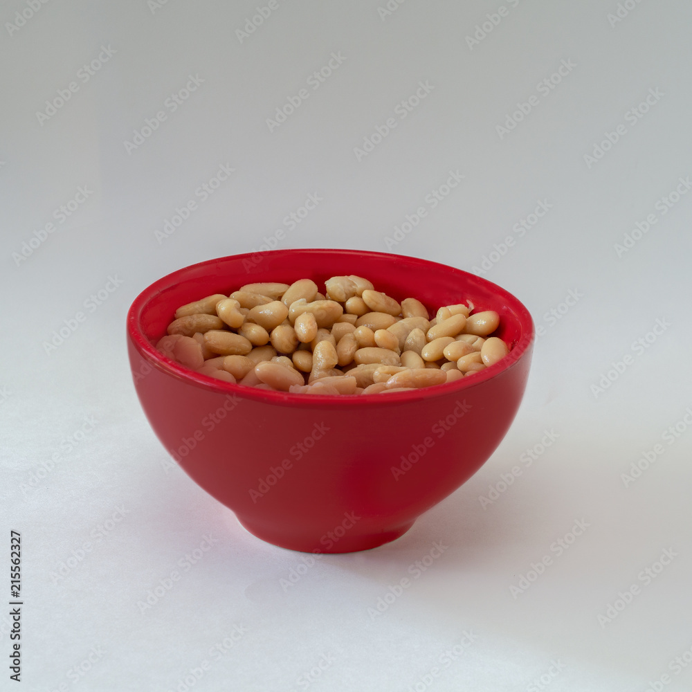 Navy beans in red bowl on white isolated Navy beans in red bowl on white isolated