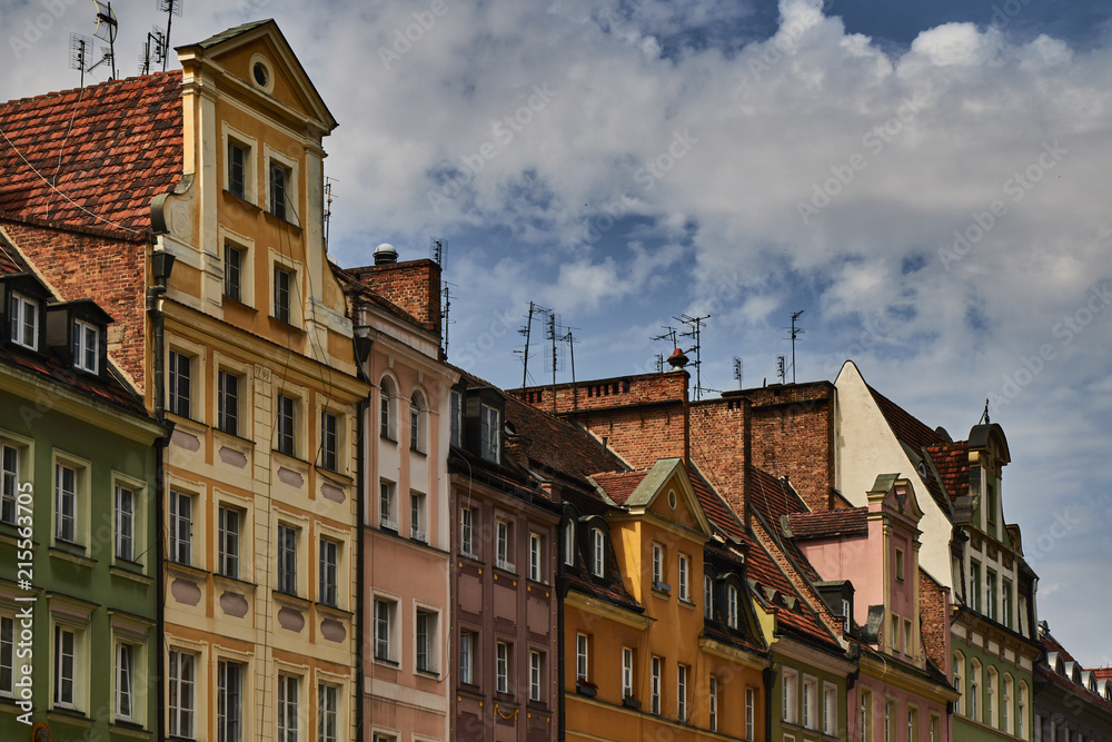Colorful historic buildings with dramatic sky in Wroclaw, Poland.