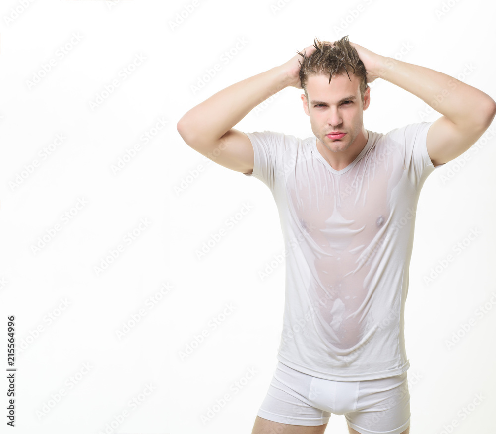 Sexy muscle man in underwear&wet white t-shirt. Masculinity, power,  strength. Sexy guy with muscular body in wet shirt&boxer shorts. Male  underwear fashion concept. Man in white underwear. Copy space. Stock Photo