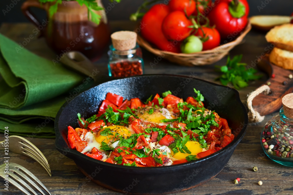 Shakshuka is a traditional breakfast of Israeli cuisine. Eggs fried in tomato sauce with pepper, onions and spices. Shakshuka is a traditional breakfast of Israeli cuisine. Eggs fried in tomato sauce with pepper, onions and spices.