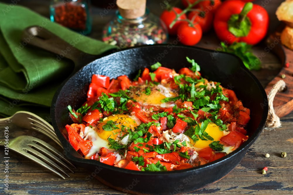 Shakshuka is a traditional breakfast of Israeli cuisine. Eggs fried in tomato sauce with pepper, onions and spices. Shakshuka is a traditional breakfast of Israeli cuisine. Eggs fried in tomato sauce with pepper, onions and spices.