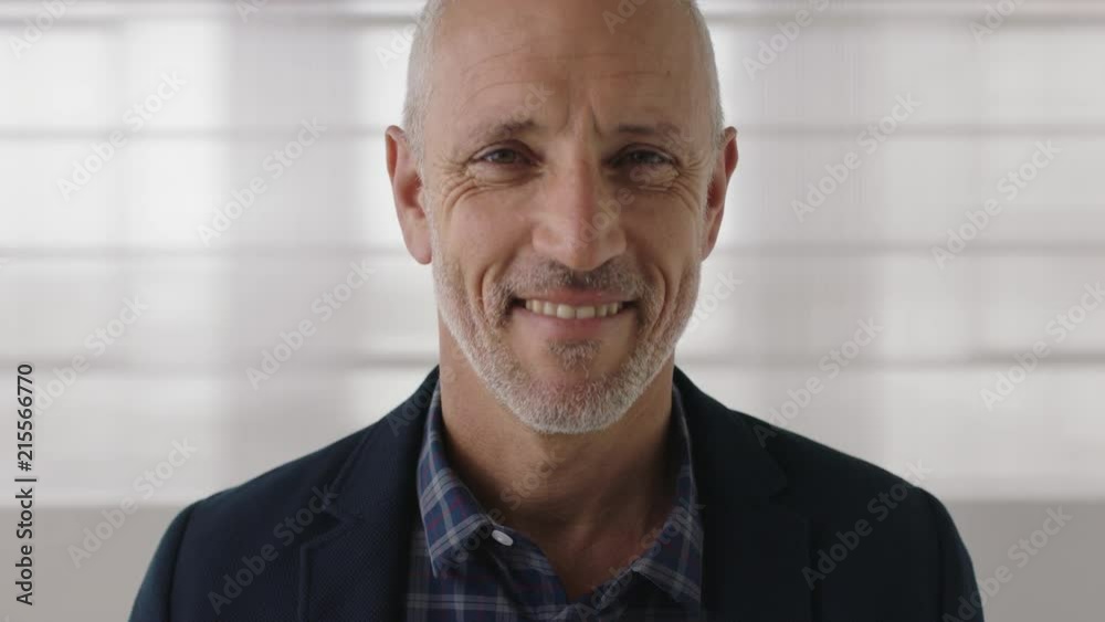 portrait of attractive mature businessman smiling confident looking at camera enjoying successful lifestyle