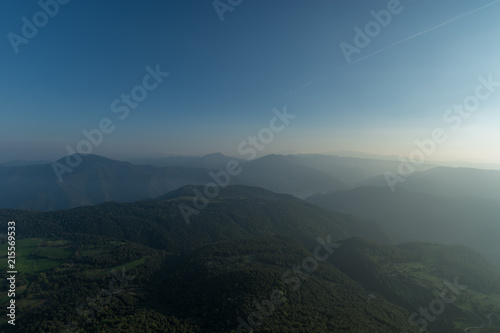 Sunbath of mountains with forests under a blue sky panorama at Catalonia, Spain © josemaria