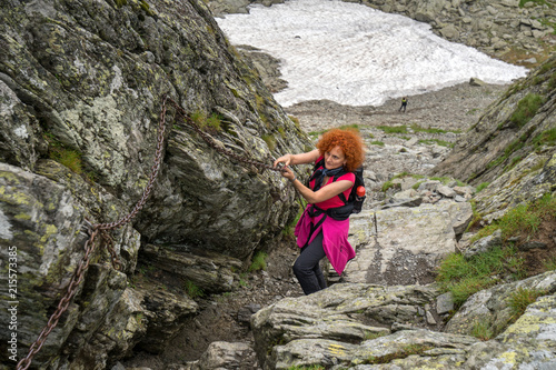 Woman hiking into rocky mountains © Xalanx