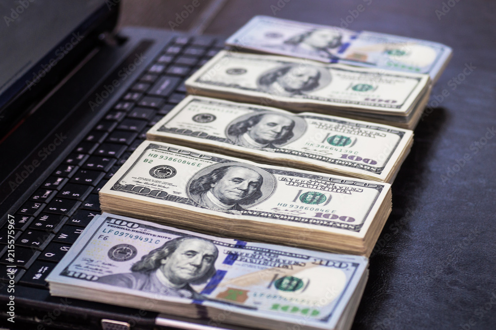 Macro shot of 100 dollar. Dollars Close Up Concept. American Dollars Cash Money. Lots of money on the laptop. Business, computers Macro shot of 100 dollar. Dollars Close Up Concept. American Dollars Cash Money. Lots of money on the laptop. Business, computers
