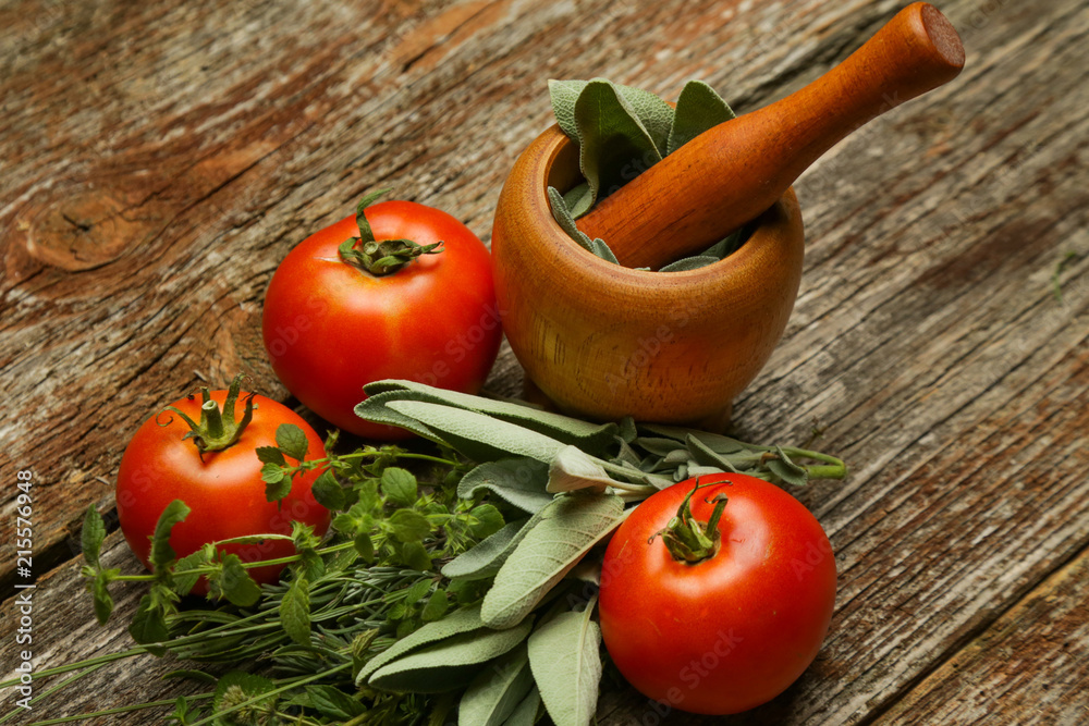 Fresh harvested tomatoes and herbs on the wooden table. Healthy organic nutrition concept.
Fresh harvested tomatoes and herbs on the wooden table. Healthy organic nutrition concept.