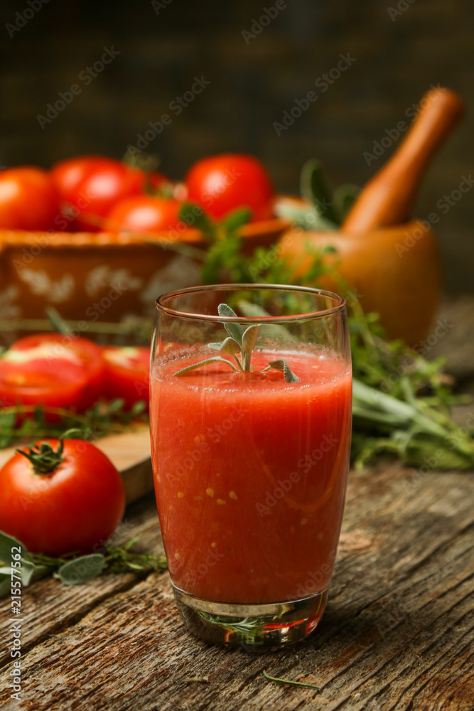 Glass of fresh tomato juice with herbs on the wooden table. Healthy organic nutrition concept.
Glass of fresh tomato juice with herbs on the wooden table. Healthy organic nutrition concept.