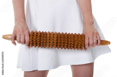 Woman holding rolling pin for maderotherapy massage photo