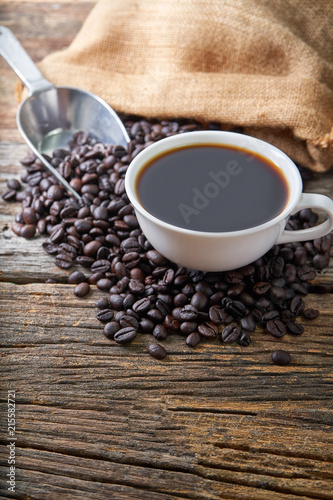 hot coffee cup on coffee beans