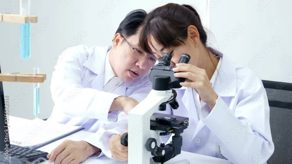 Male scientist advise to team how to work. Asian Scientist working together at laboratory. People with medical, science, doctor, healthcare concept. 4K Resolution. Male scientist advise to team how to work. Asian Scientist working together at laboratory. People with medical, science, doctor, healthcare concept. 4K Resolution.