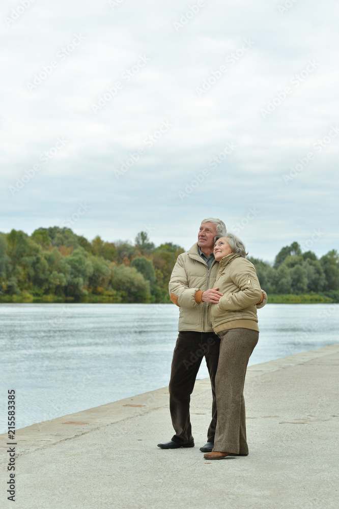 Happy senior couple near water