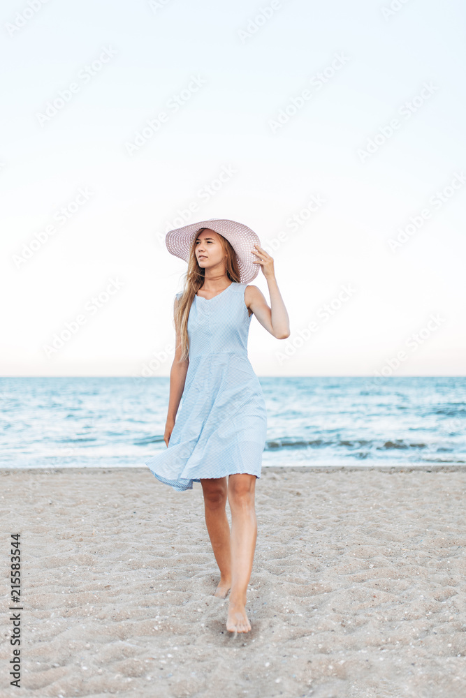 Beautiful portrait of a girl in a hat close-up, rest on the sea or ocean, a woman in a summer dress
