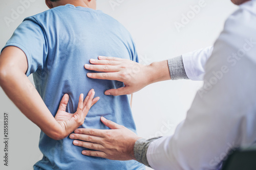 Doctor consulting with patient Back problems Physical therapy concept photo