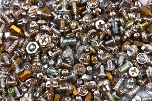 Background of many randomly scattered screws