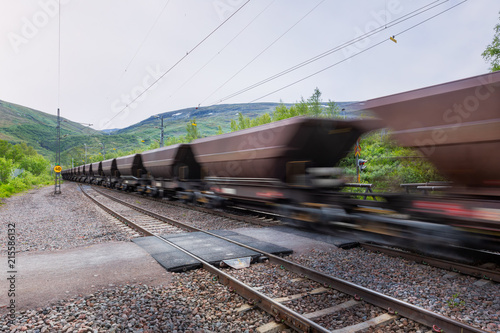 Iron ore Train passes between Kiruna and Narvik with motion blur in the mountain scenery of northern Sweden.