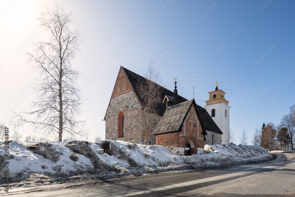 Fototapeta premium Winter view over gammelstad church, an UNESCO world heritage site close to the city of Lulea, Sweden.