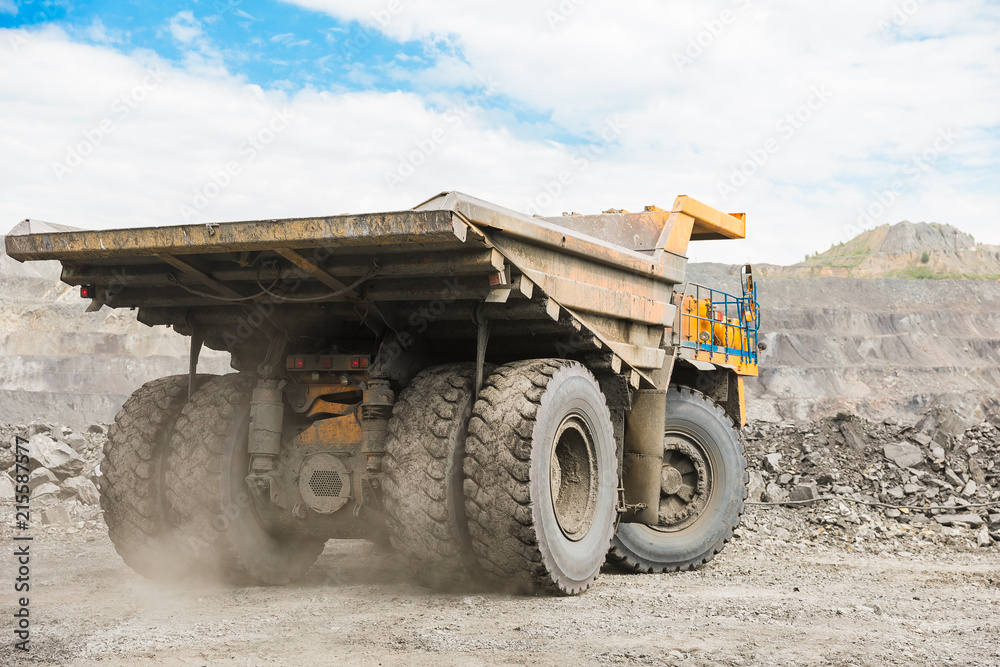 Large quarry dump truck. Loading the rock in dumper. Loading coal into body truck. Production useful minerals. Mining truck mining machinery, to transport coal from open-pit as the coal production. Large quarry dump truck. Loading the rock in dumper. Loading coal into body truck. Production useful minerals. Mining truck mining machinery, to transport coal from open-pit as the coal production.