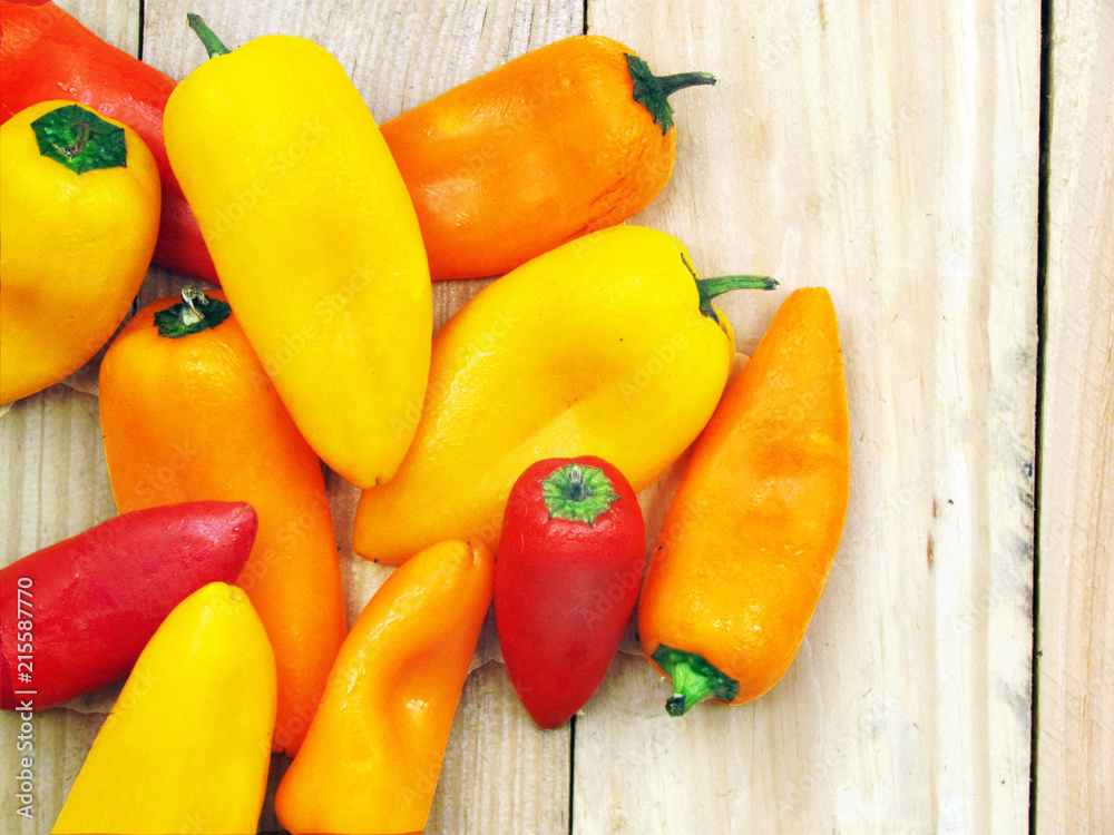 Sweet Peppers in a Bunch on a Wooden Board Sweet Peppers in a Bunch on a Wooden Board