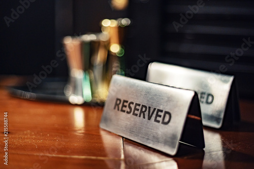 Reserved sign on a wooden table..