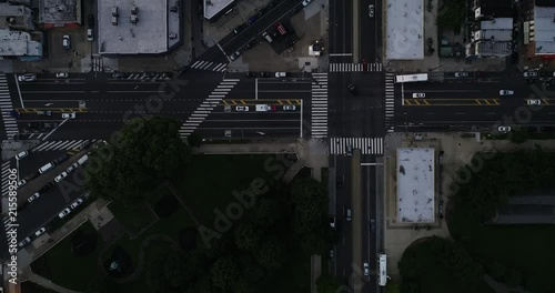 Cars crossing intersection at sunset in Philadelphia.