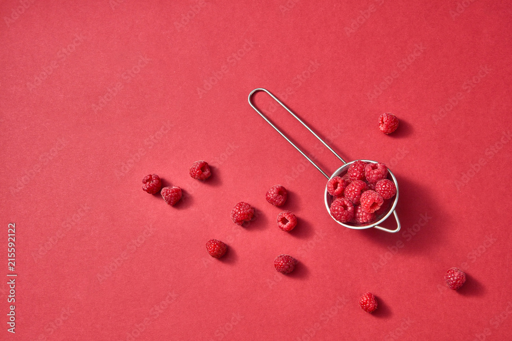 Freshly picked sweet raspberry on a red paper background. Colorful organic berries pattern. Freshly picked sweet raspberry on a red paper background. Colorful organic berries pattern.