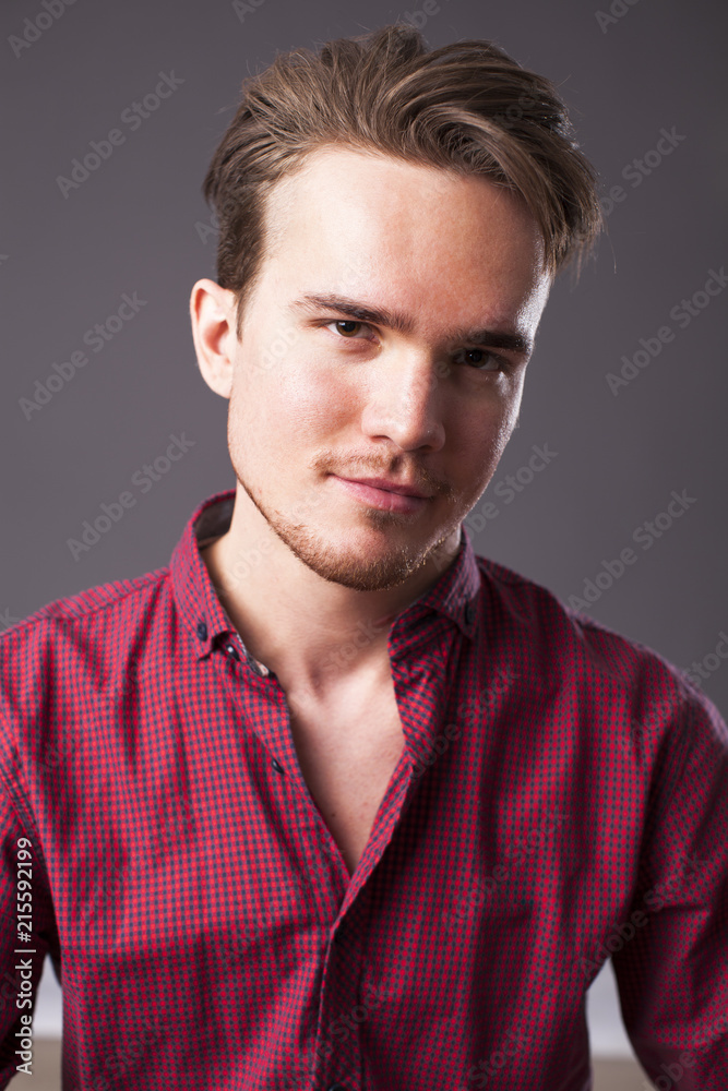 Studio portrait of young man on a dark background Studio portrait of young man on a dark background