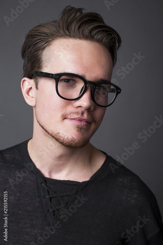 Studio portrait of a young man in big glasses