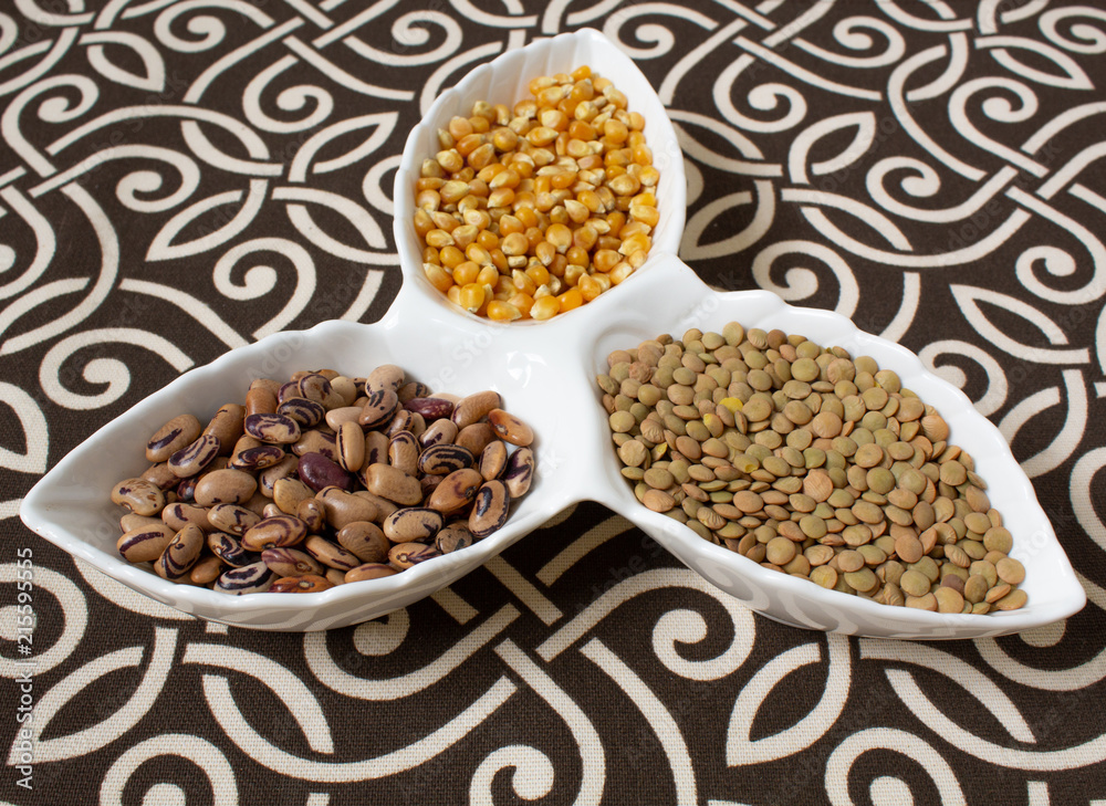 Fototapeta premium Various cereals, cereals. Different types of grits in cups on a patterned background. Corn, beans. Healthy eating. Still life.