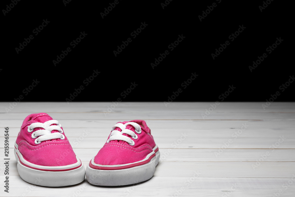 old secondhand pink canvas shoes or sneakers for kid or child and baby foot  on vintage