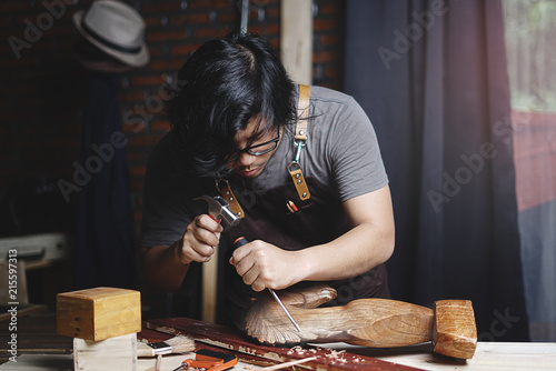 Fotografie, Obraz Asian Carpenter Working in Woodworking Workshop