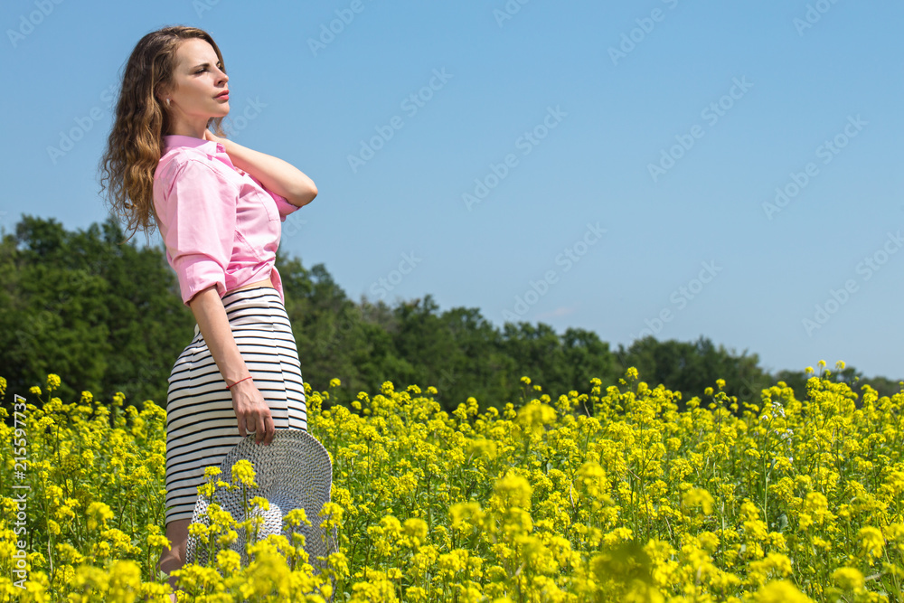 Beautiful woman on a flowering meadow