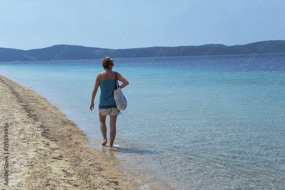 Women walking on an empty beach feeling relaxed